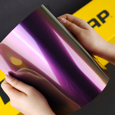 Hands holding a A4 sample of TeckWrap RD18-HD Crazy Grape Vinyl Car Wrap
