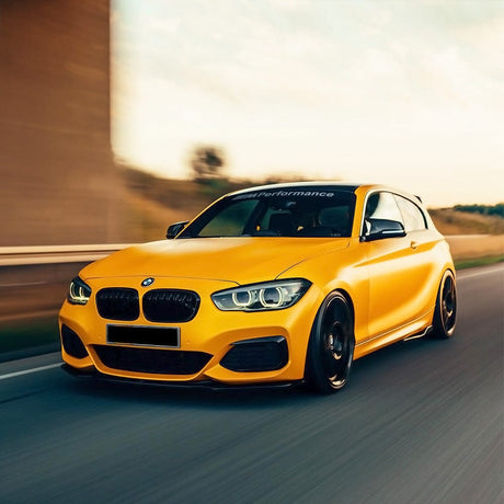 BMW 1 Series wrapped in TeckWrap Hornet Yellow (ECH16) Satin Vinyl, showcasing a bold, energetic yellow satin finish that enhances the car’s sporty look — ideal for dynamic automotive restyling.