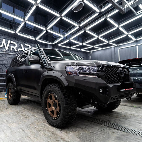 Rugged Toyota SUV wrapped in TeckWrap Brushed Black vinyl, demonstrating its bold, structured finish and robust appearance.